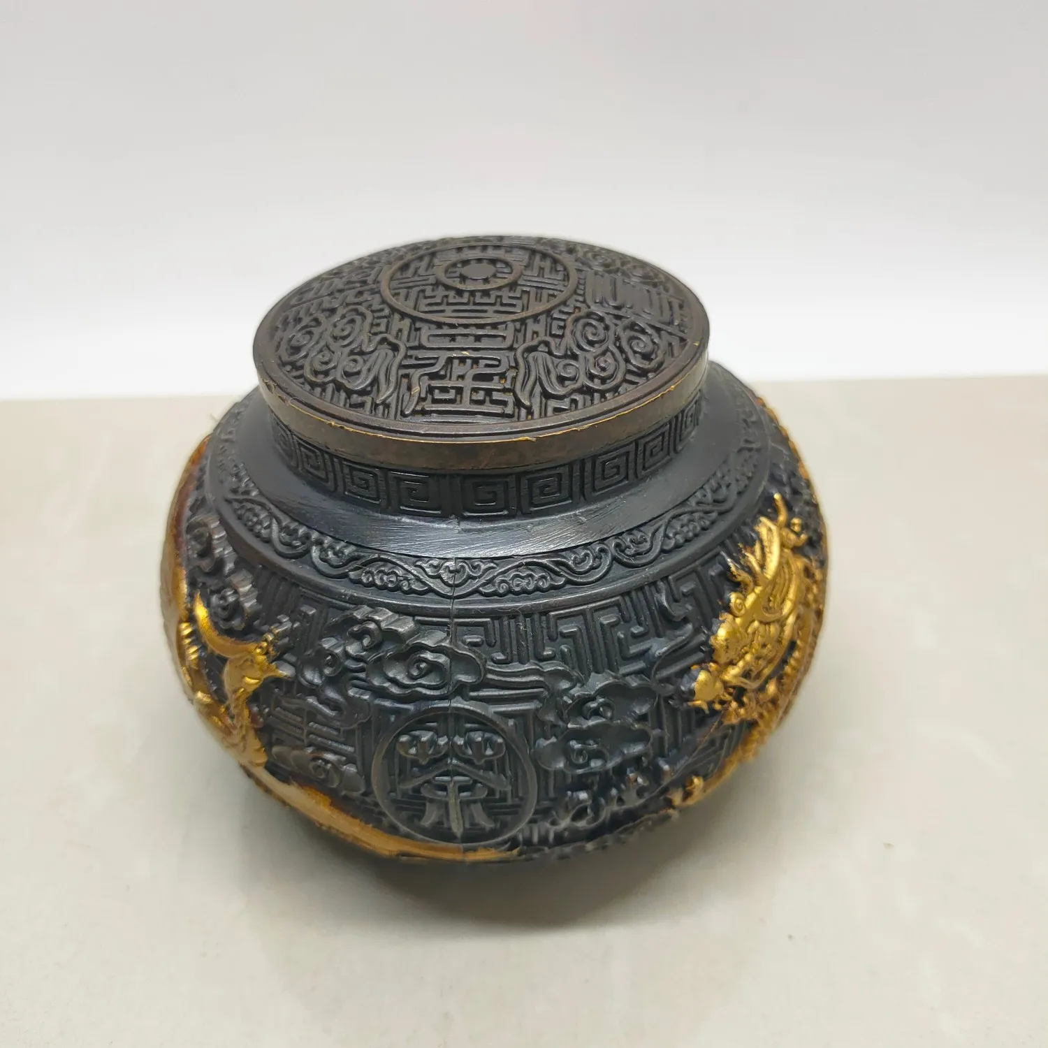 

A dragon-and-phoenix tea canister made of brass imitation purple copper gilded with antique craftsmanship.
