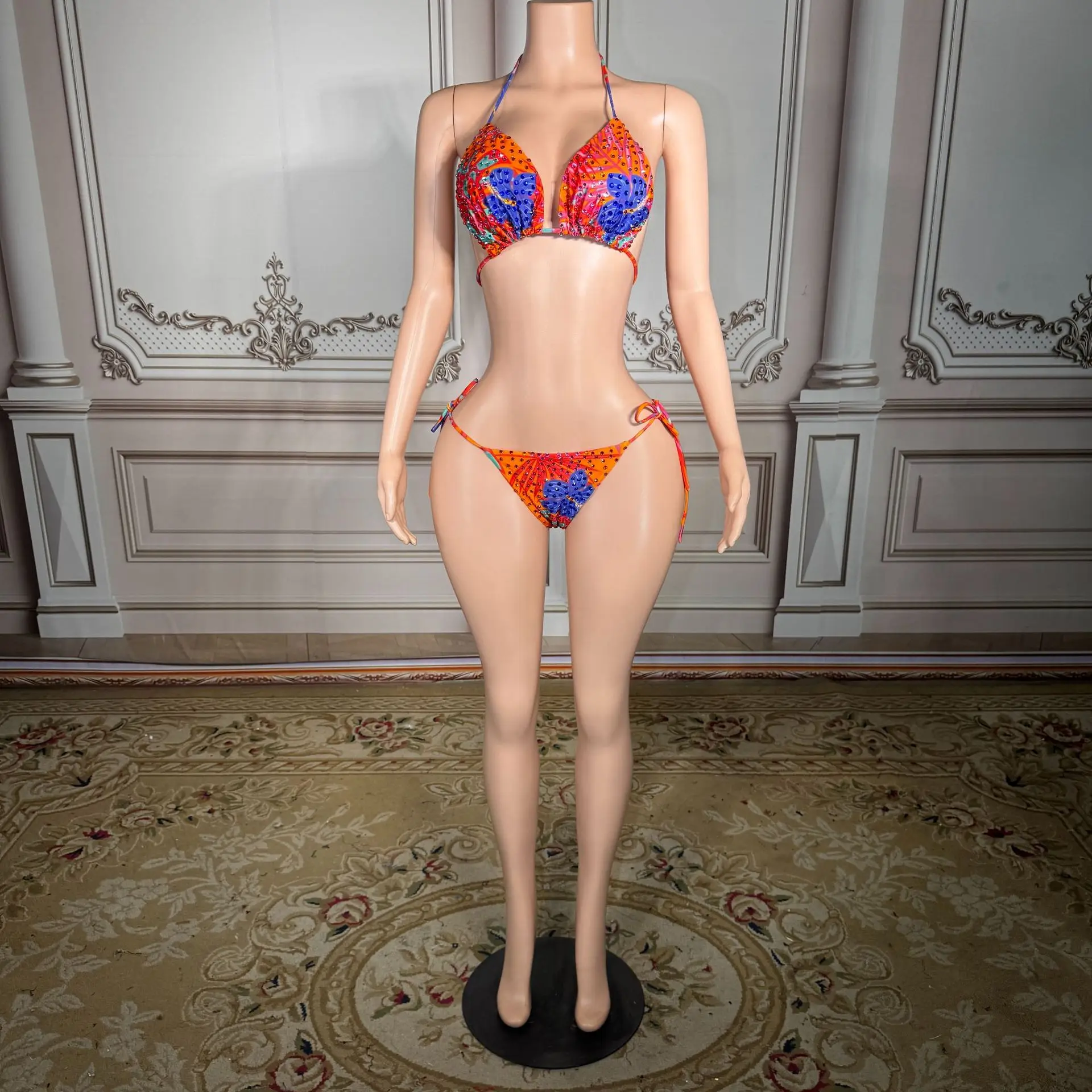 Printed triangular cup-front backless bikini with contrasting blue edges and laces for a beach vacation outfit
