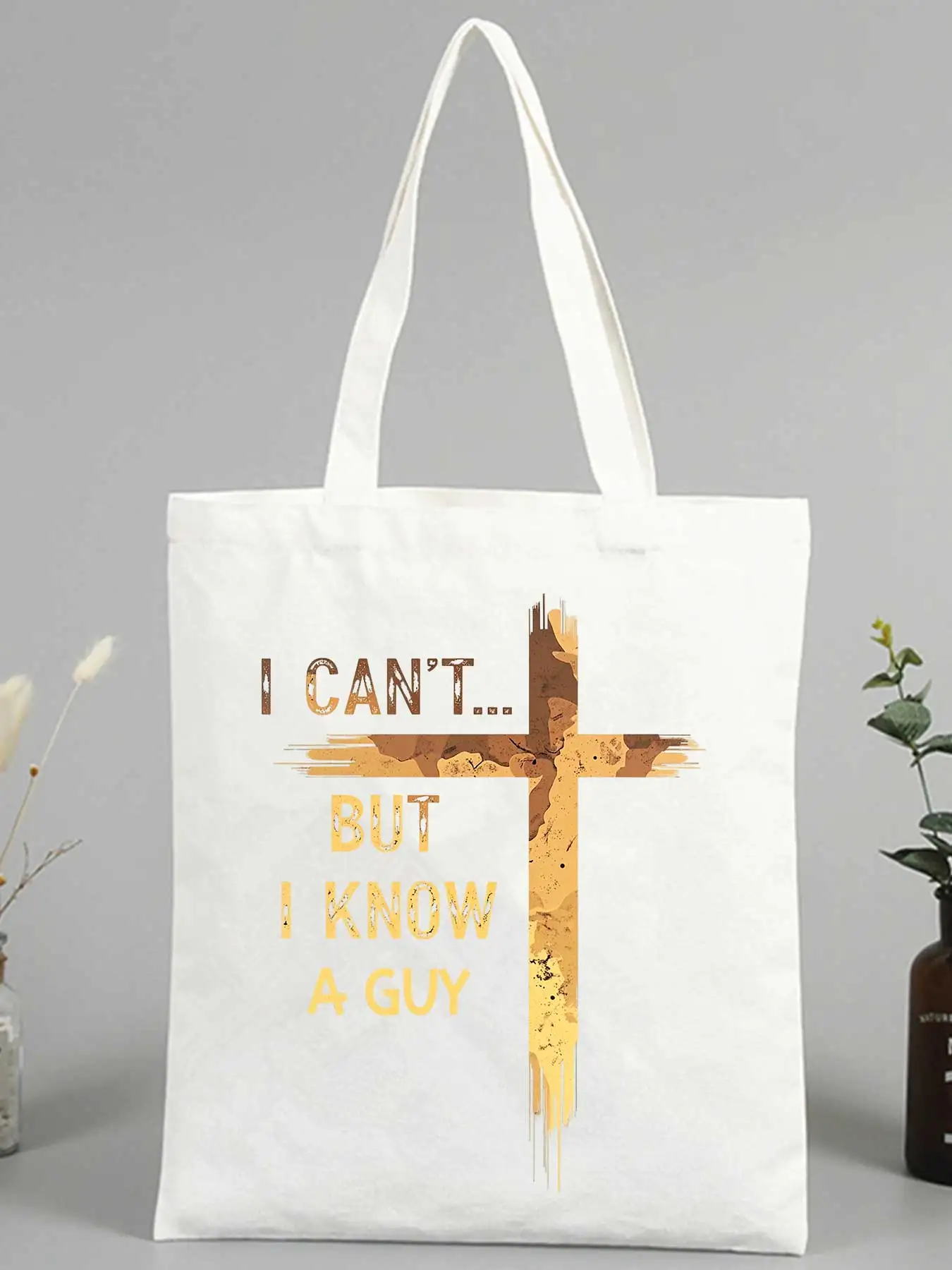 Christian-inspired canvas tote bag with cross and typography print, ideal for daily use and casual outings
