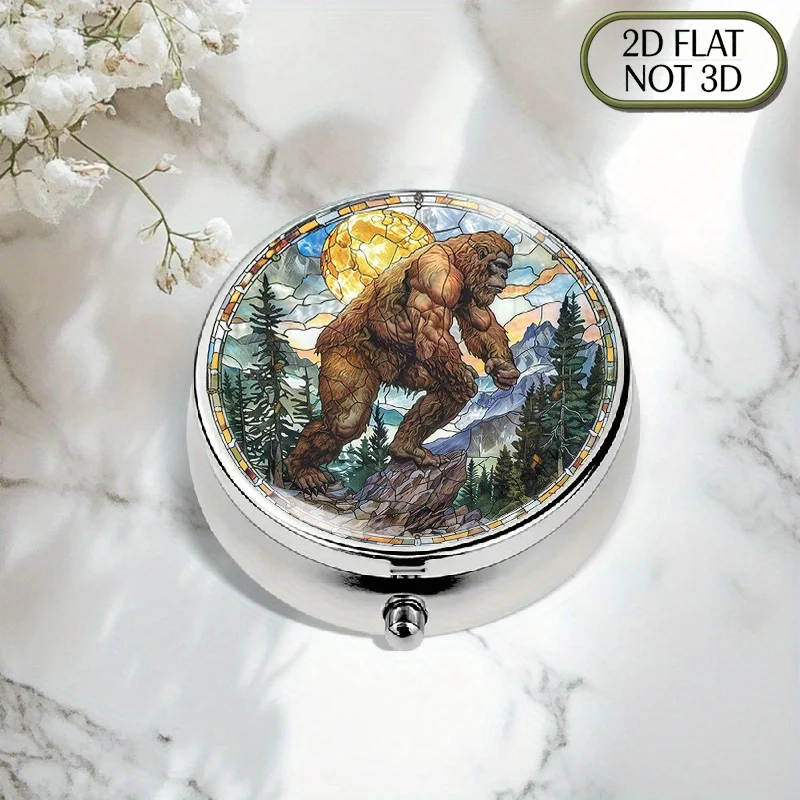 A flat, portable, round metal pill box featuring a vibrant Bigfoot Mountain stained glass design, ideal for storing and organizing medication, perfect for storing vitamins and for multi-purpose storage, also great for small accessories and coins