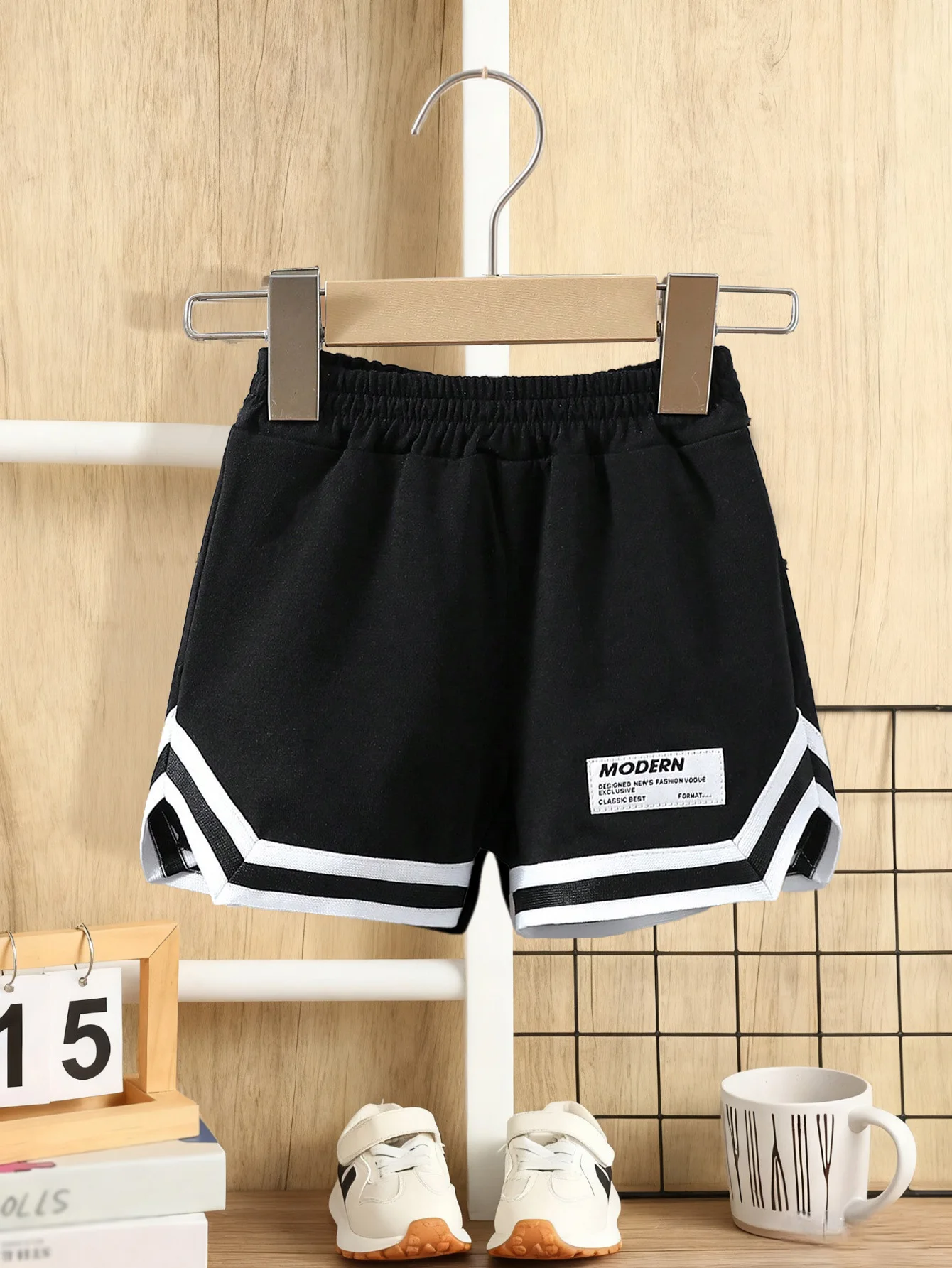 

Little boy's black sports shorts, contrasting stripes with MODERN label, summer loose casual pants, baby boy's clothing.