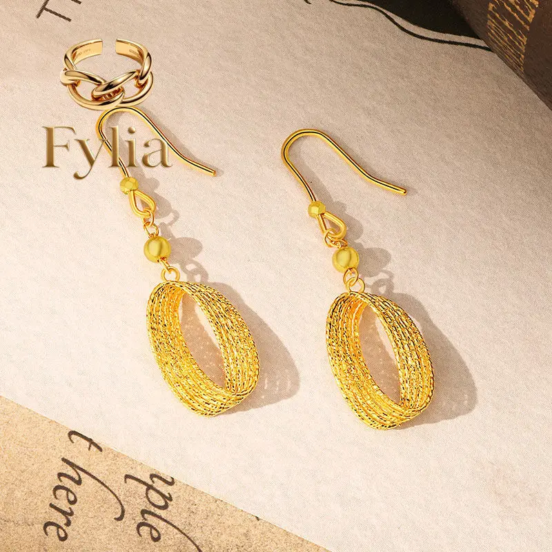 

Fylia Jewelry Gold store same style Mobius light and shadow earrings 24K real gold ear hooks hollow brushed light luxury 9999