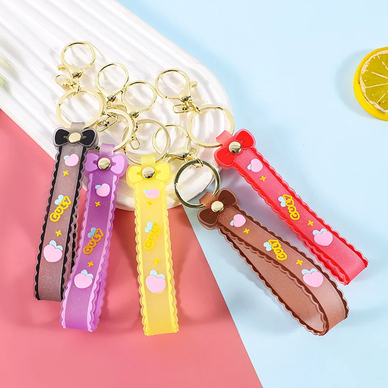 سلسلة مفاتيح من حبل جلدي على شكل فيونكة شفافة من السيليكون اللامع من Minso مع حقيبة كرتونية على شكل دمية زيتية وإكسسوارات هدايا