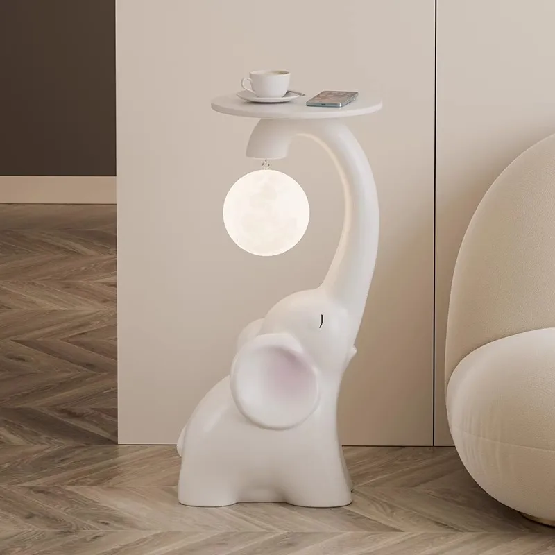 

Living room large floor-to-ceiling moon elephant ornament TV cabinet next to the sofa tray storage light luxury decorations