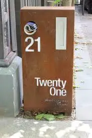 Red metal mailbox, modern mailbox, corten steel letter box with hanging wall planter