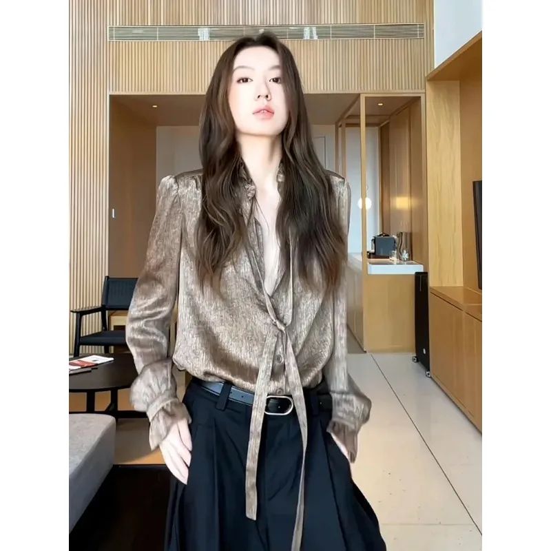 

Женская блузка из атласа цвета шампанского с завязками на шее, длинными рукавами и блестящей текстурой