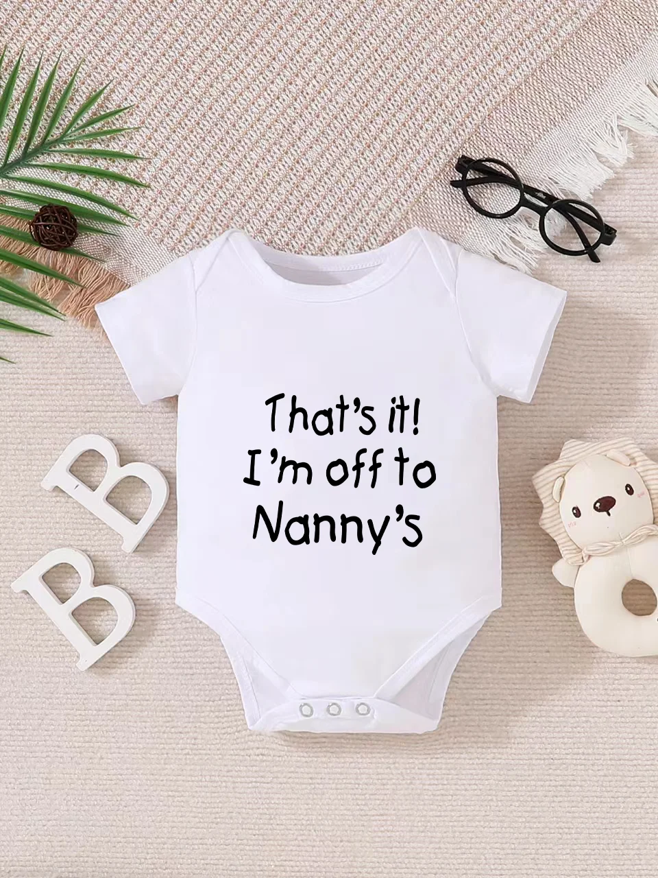

Playful letter-printed baby short-sleeve triangle bodysuit. Button closure for easy dressing, machine washable