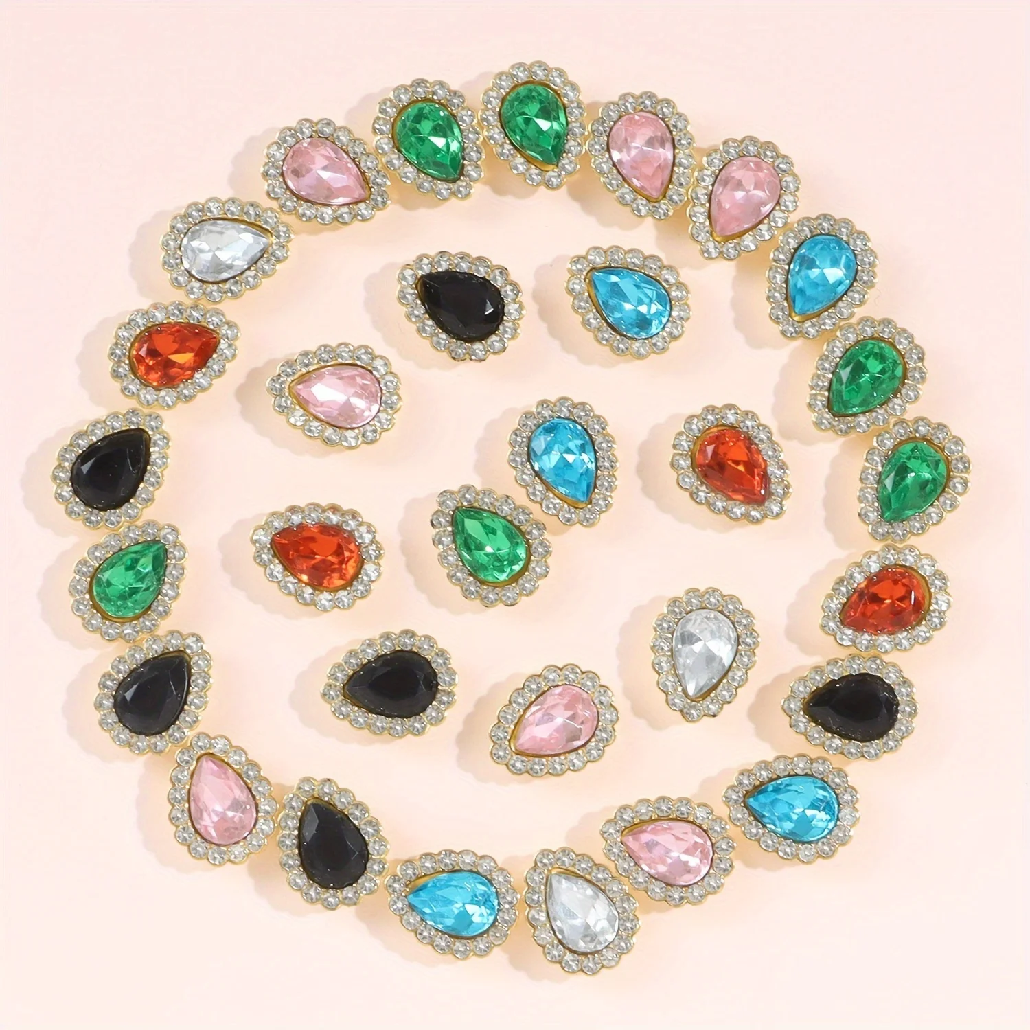 

A set of 25 teardrop-shaped faux diamond beads with a lace plastic base. A delicate DIY decorative accessory.
