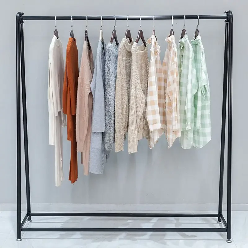

store special display floor-to-ceiling golden wrought iron shelf display children's clothing women's clothing store clothes pole