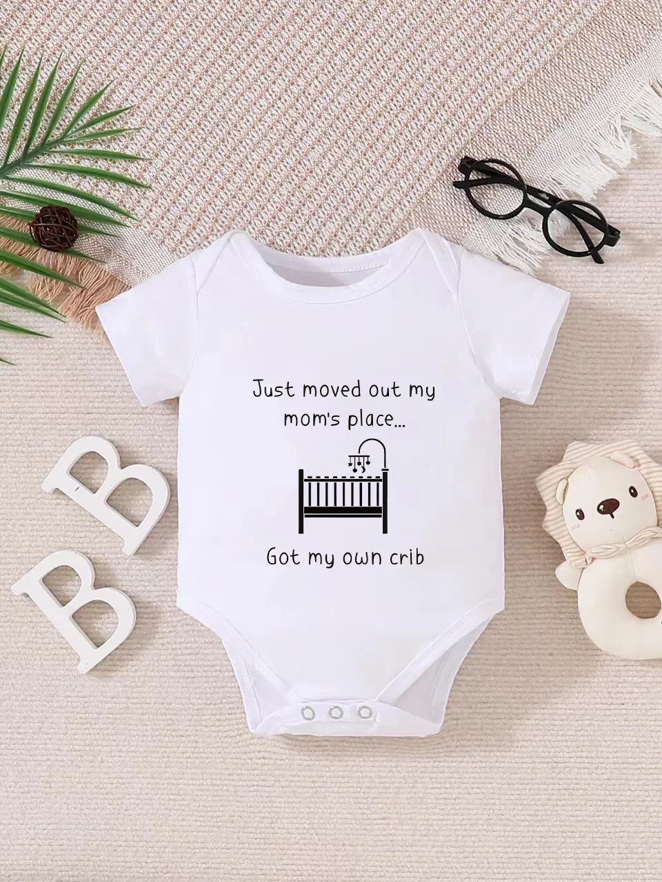 Playful letter-printed baby short-sleeve triangle bodysuit. Button closure for easy dressing, machine washable