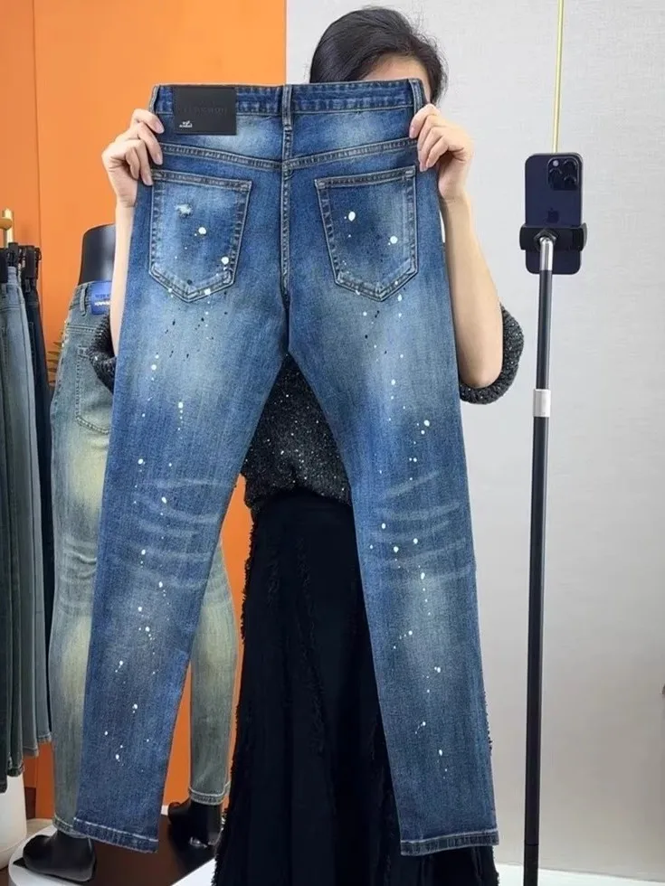 

Модные мужские джинсы слим-фит, весна-лето, новинка, европейский стиль, с эффектом разбрызгивания чернил, с перфорацией, трендовые, повседневные...