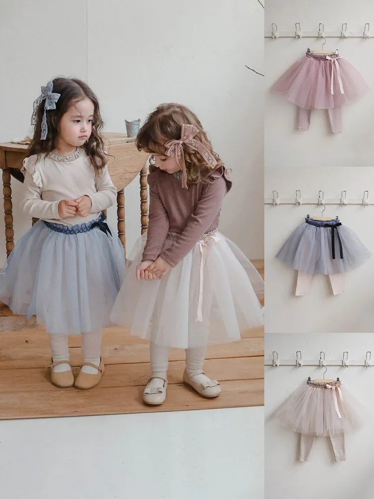 

Кусочки корейских детских и девочек юбок с сетчатыми галстуками-бабочками, свободными и узкими талиями и элементарной юбкой с накладным подолом