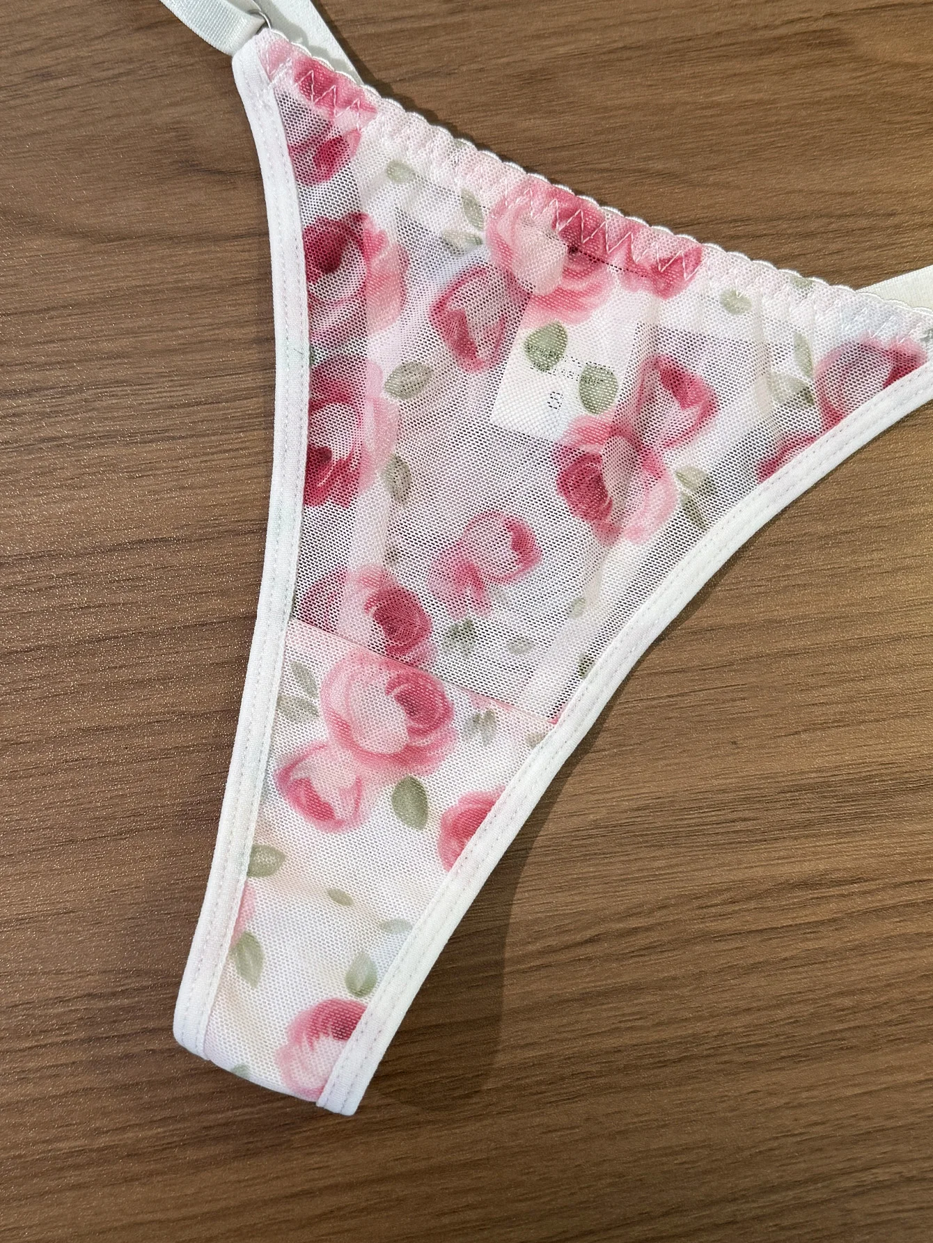 Matching thong detail with rose print mesh and delicate strap design