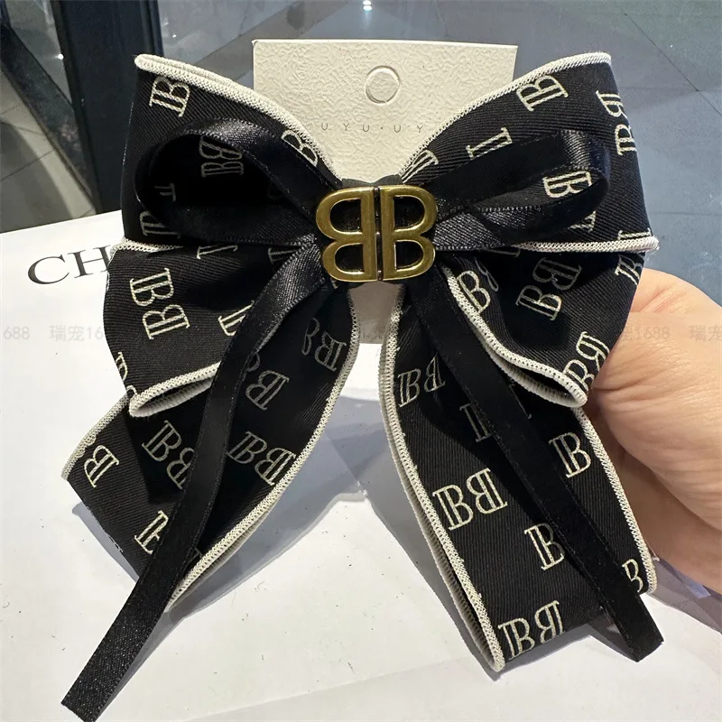 

Black and white large bow headband 2025 new letter hair clip with spring clip and ribbon at the back of the head