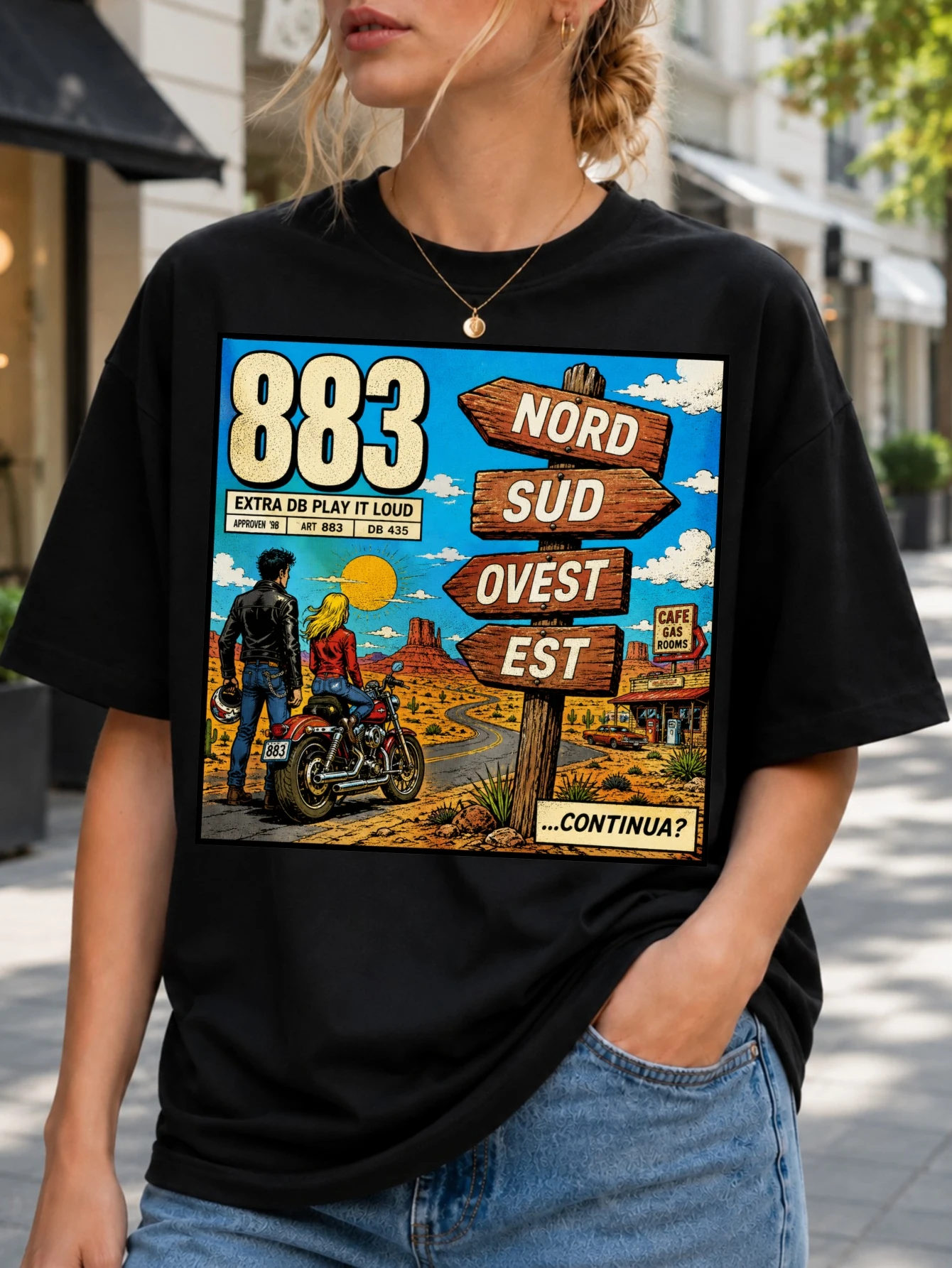 883 Extra DB Play It Loud comic desert road scene with motorcycle travelers wooden direction signs  Unisex All T-Shirt