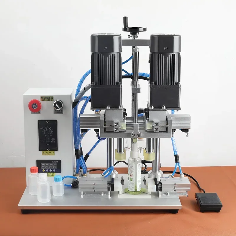 Small 220V semi-automatic pneumatic duckbill-style capping machine for glass and plastic bottles with screw caps.