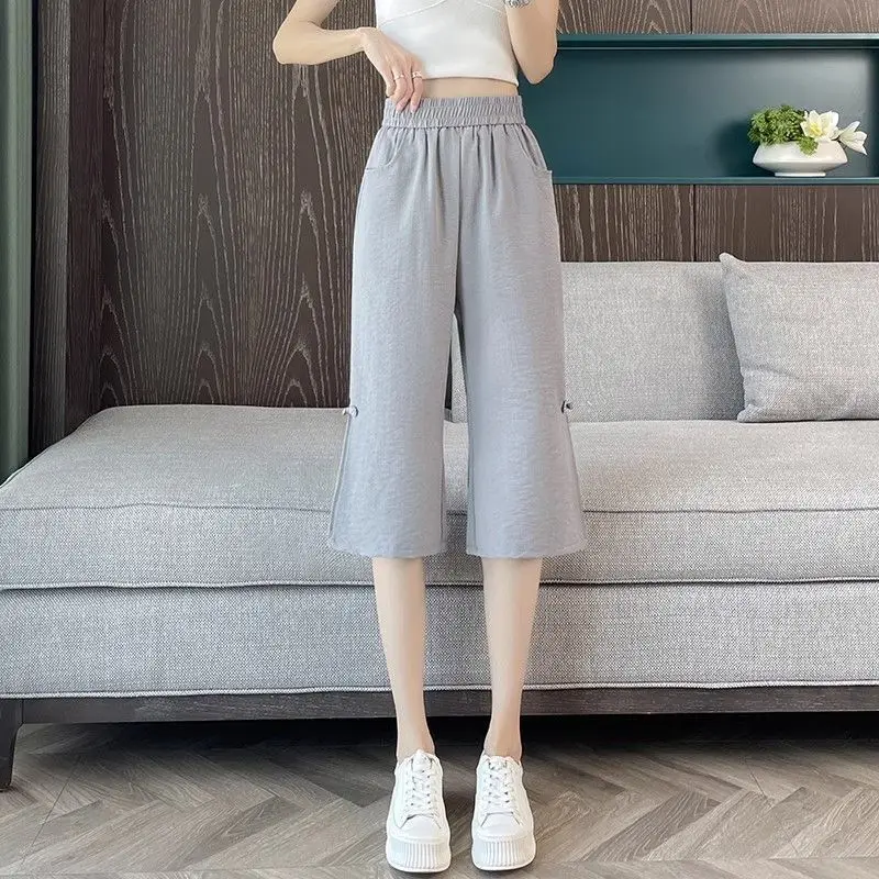 Moda Tasche impiombate elastiche Pantaloni svasati con bottoni Abbigliamento femminile 2025 Estate Nuovi pantaloni a vita alta vintage in tinta unita allentati