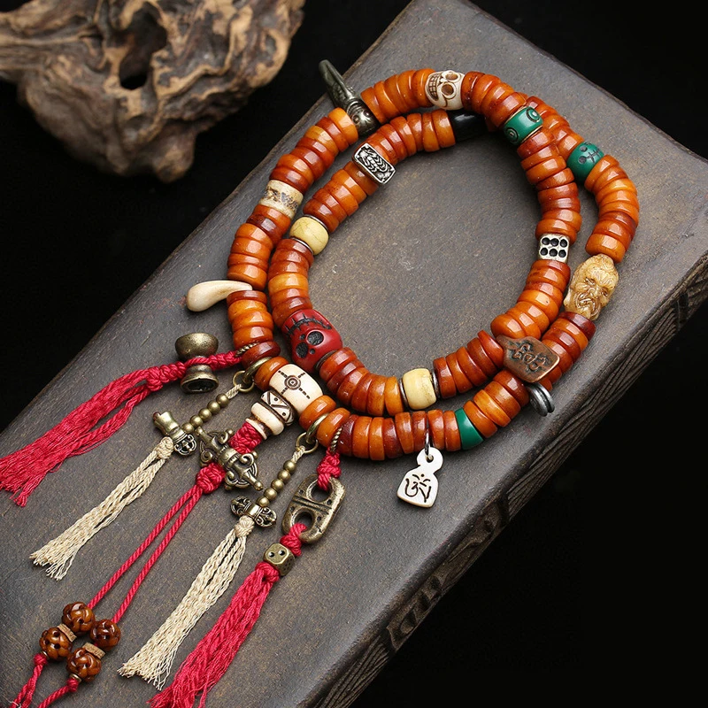 

Tibetan-style multi-strand hand-held prayer with 108 bone beads and copper accessories