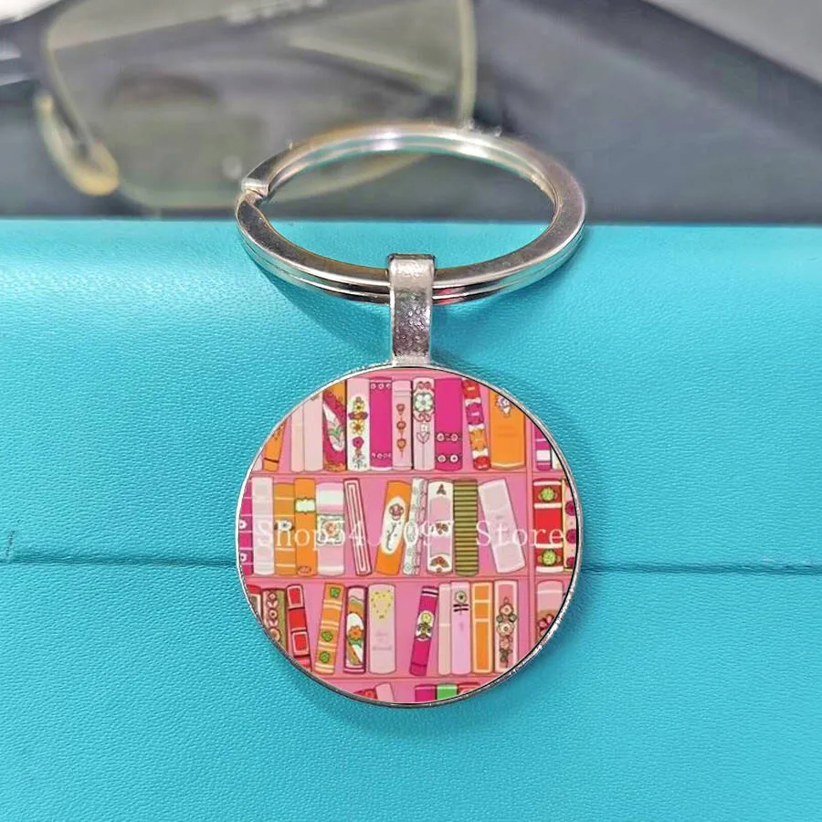 Classic flat keychain with colorful book and bookshelf patterns, suitable as a gift for students and teachers