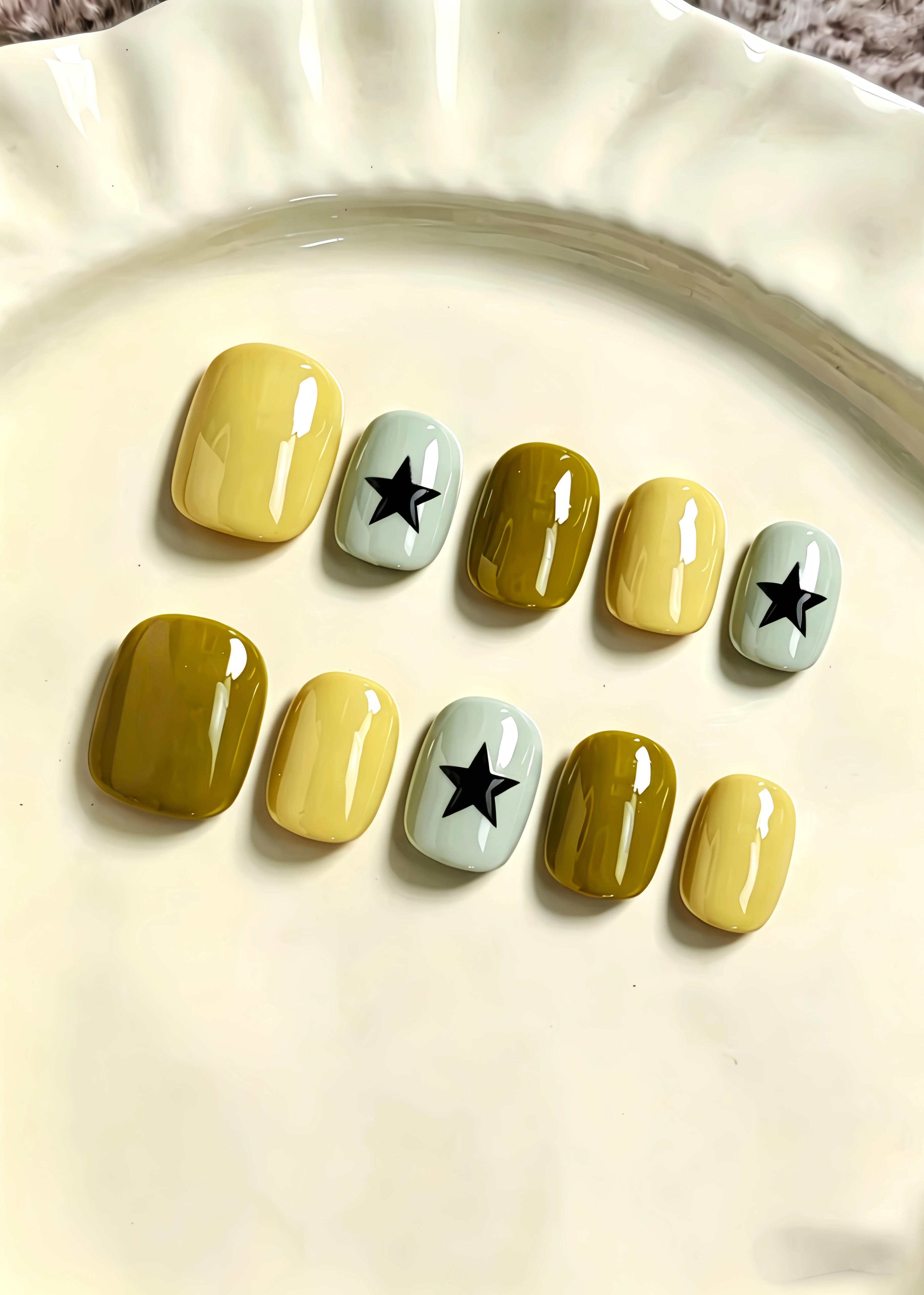 10 Short Square-Shaped Nails, with a Base Color of Creamy Yellow, Ginger Green, and Light Blue-Gray, Featuring a Hand-Painted Black Star Design for a Stylish and Minimalist Look. Press-On Fake Nails with Low-Saturation Morandi Color Scheme, Suitable for Daily Outings, Workplace, Study, Campus Life, Dating, Shopping, and as Nail Art Stickers. Fake Nails for Sweet Girls, Mature Women, Students, Travel, and Photo Shoots. Includes One Jelly Glue and One Nail File.