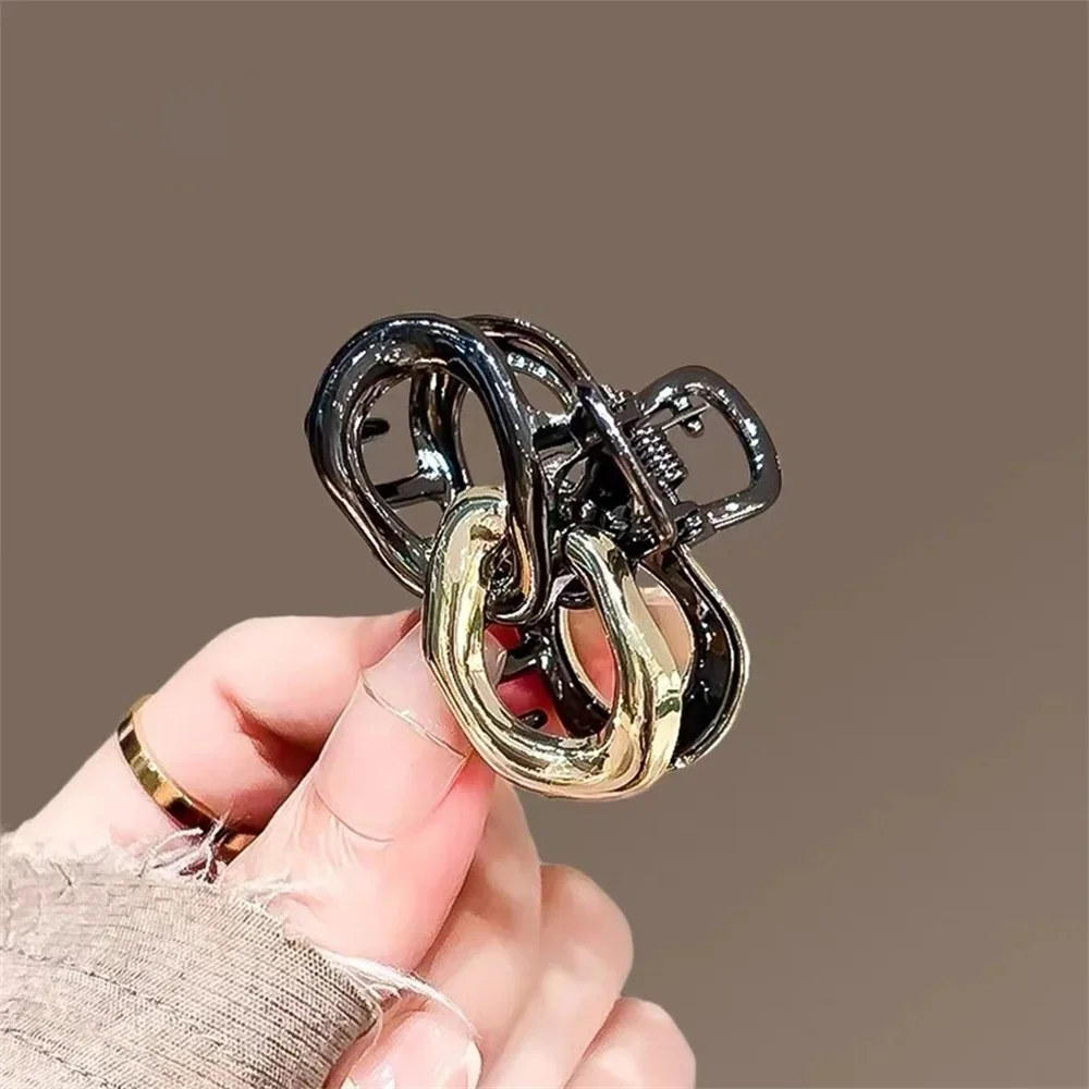 Small Hair Claw Clip Women Dual Interlocking Loop Design Glossy Black and Gold Plated Metal Alloy view 3