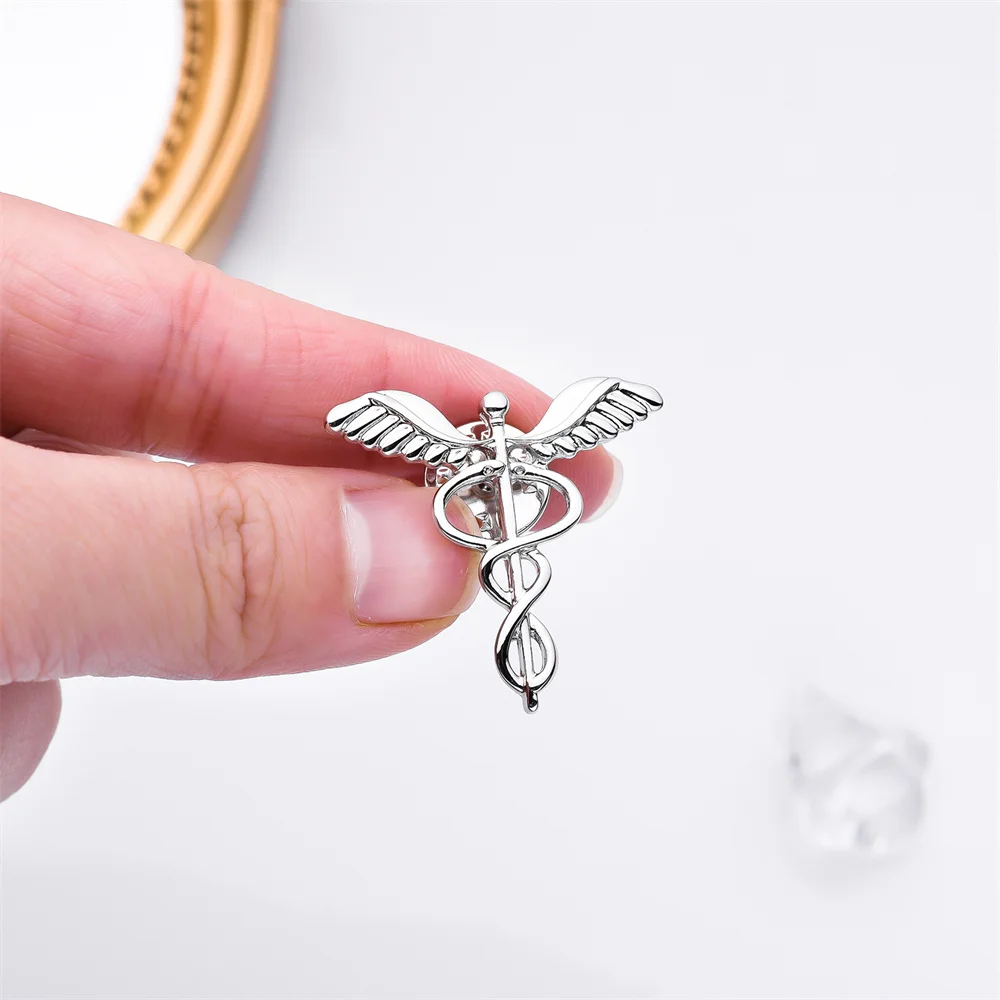 

Asclepius Snake Scepter God's Wings Metal Pin Fashion Medical Brooch Badge for Medical Students Teacher Internship Gift