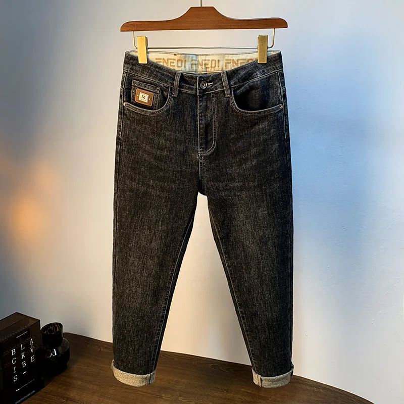 2024 autunno nero grigio Jeans pantaloni Harem affusolati leggermente larghi alla moda da uomo pantaloni comodi elasticizzati stampati a vita media