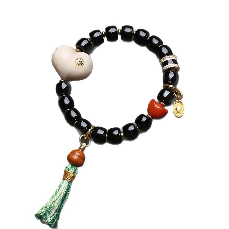 Natural black agate bracelet with barrel beads, reverse-flow bone, peace knot, ivory fruit, peach, monkey head and bodhi seeds - view 6