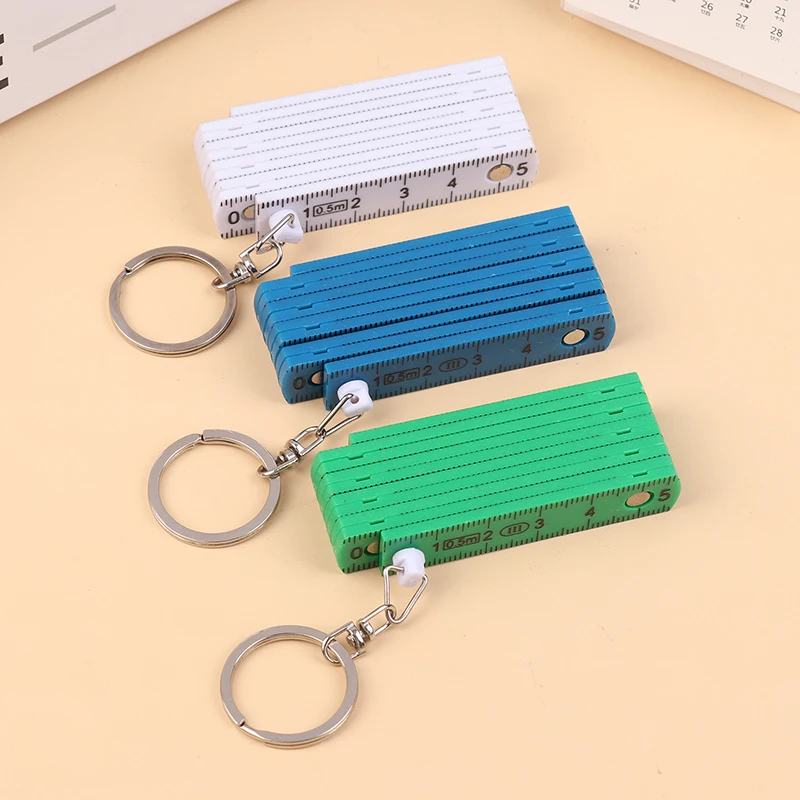 1ชิ้น0.5เมตร10พับพวงกุญแจพลาสติกความแม่นยำสูงไม้บรรทัดพับเก็บได้สำหรับการเดินทางงานไม้อิฐบ้าน DIY