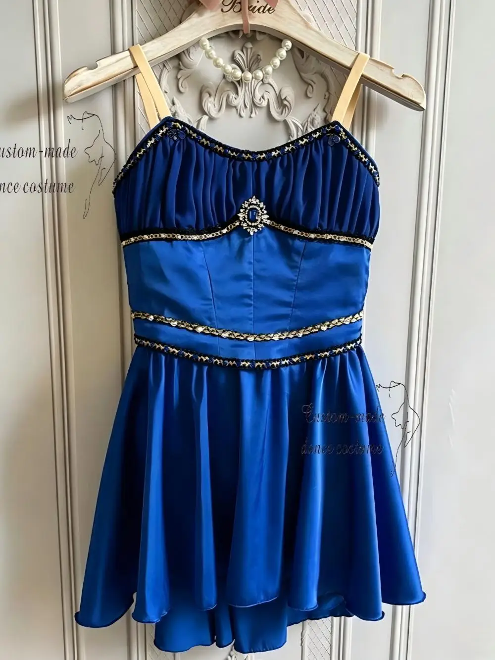 

Royal blue camisole ballet dress decorated with silver sequin trim and central sapphire rhinestone ornament, glossy satin flare