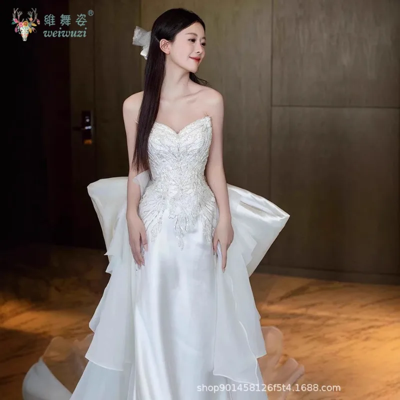 2025 nuevo vestido de novia de satén de estilo francés, vestido de novia de cola grande con lazo bordado de cuentas hecho a mano exquisito sin tirantes a la moda