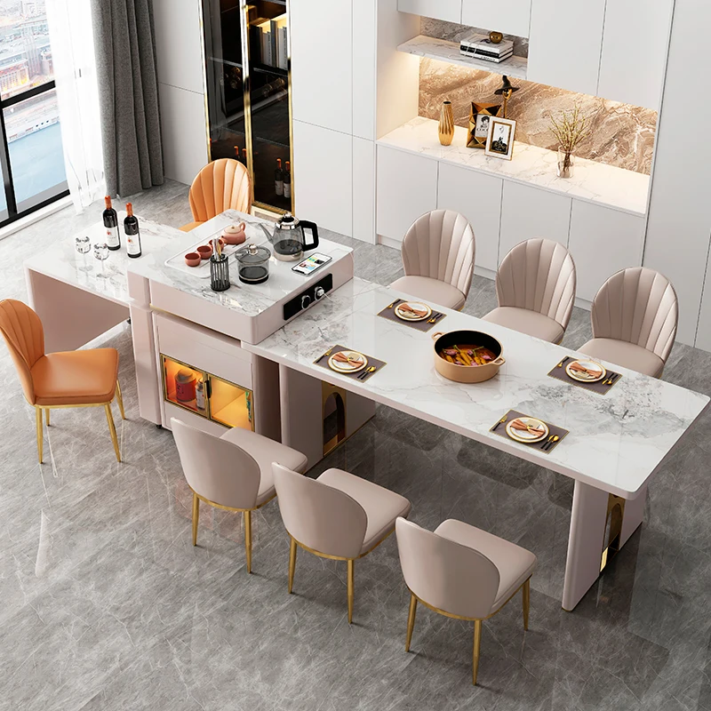 Telescopic slate island are integrated into a light luxury multi-functional large dining table with induction cooker