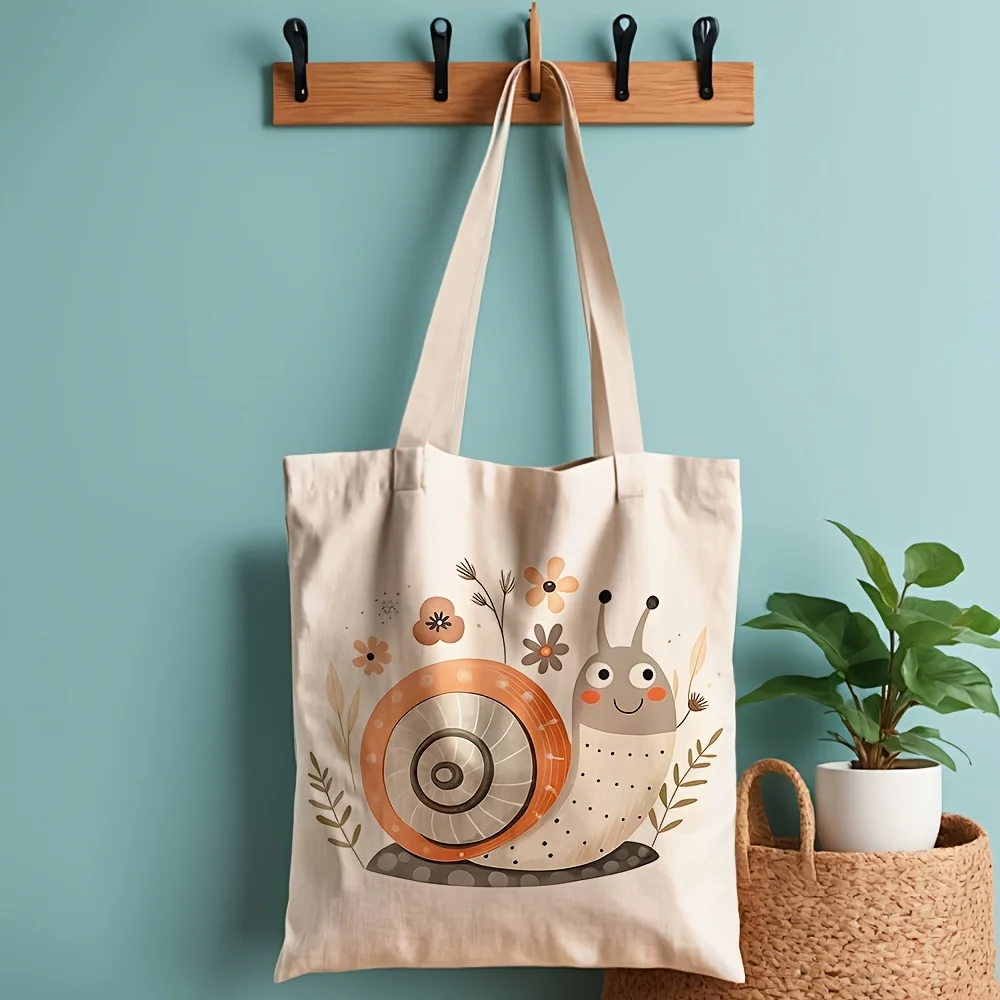 A Cute snail pattern printed canvas tote bag, suitable for daily use, shopping, school, and travel