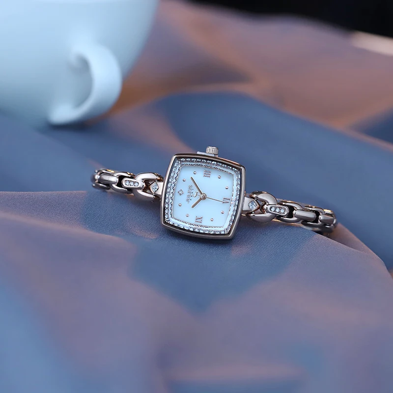 

New trendy and fashionable women's bracelet watch with a thin square strap and delicate diamond quartz. Women's accessories.
