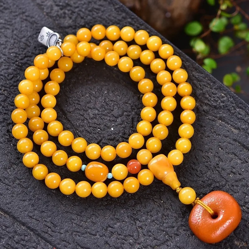 Natural with three strands featuring a rich golden-yellow amber color and 925 silver accents The bracelet is