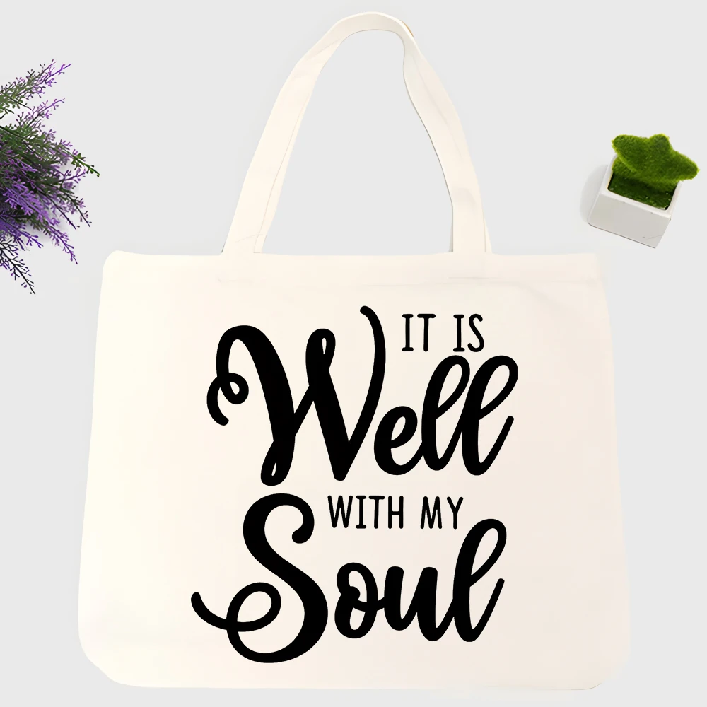 Women's typography print canvas tote bag with handwritten text design, perfect for daily shopping and casual outings