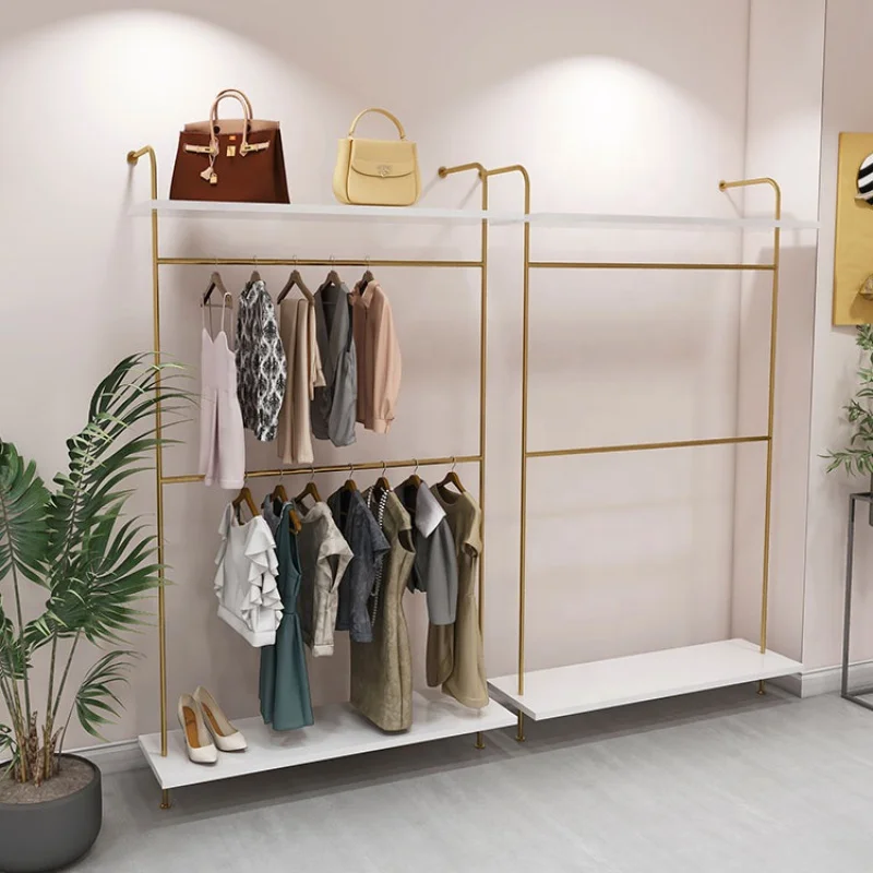 custom，Custom Beautiful Gold Wall Mounted Garment Display Rack Shelf Retail Clothing Shop Interior Layout Design