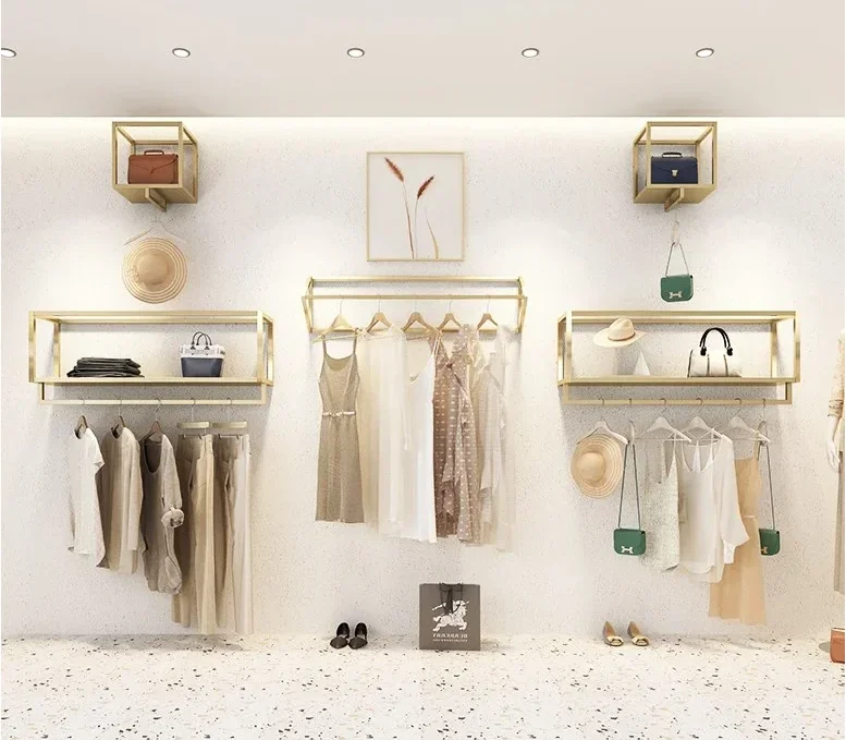 

Wall mounted display shelf in clothing store Gold shelf decoration Wall mounted hanging shelf in women's clothing store