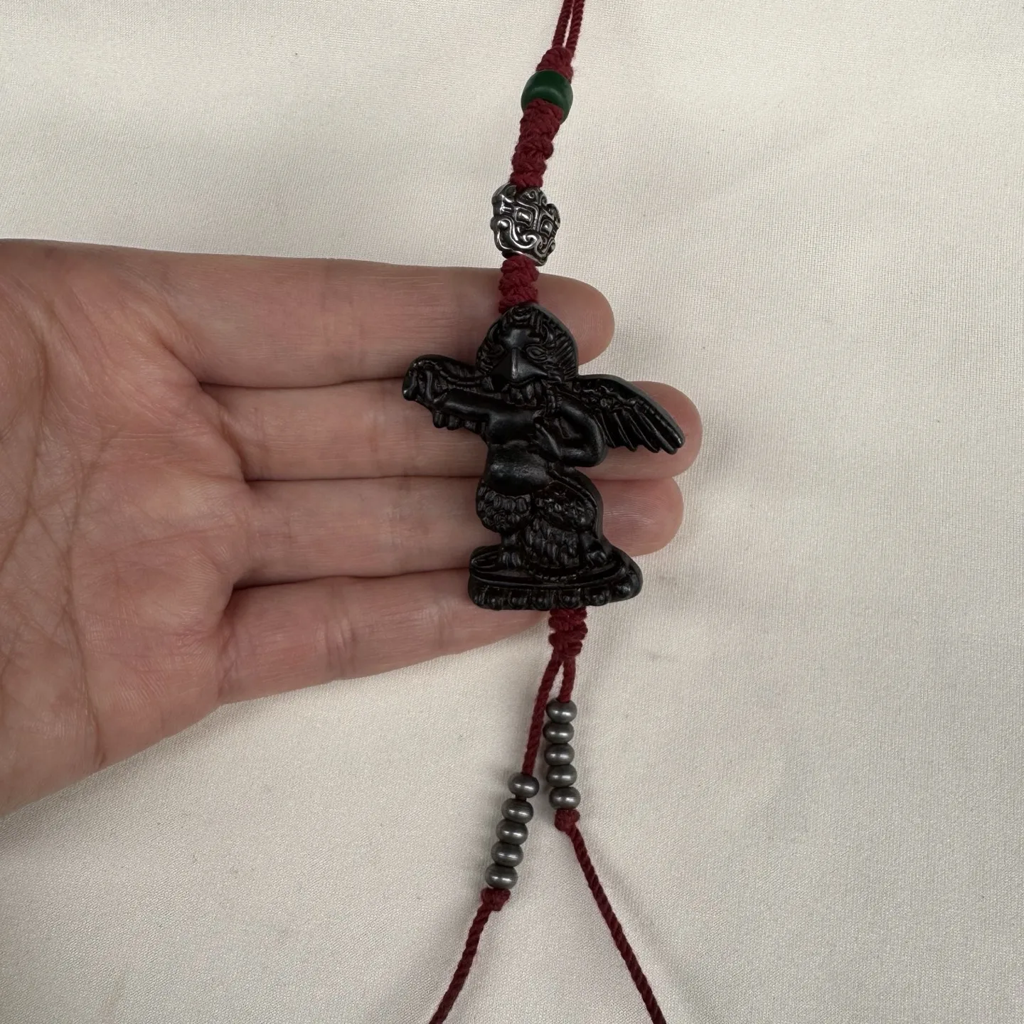 

A Chinese retro ethnic style great Peng bird bag with a talisman pendant