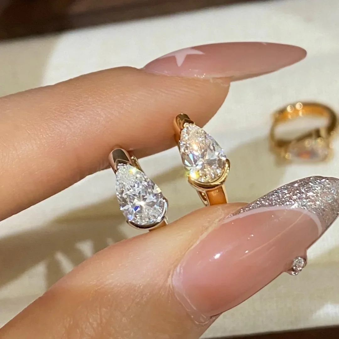 QIBAOKU 0.5CT 1CT Oval Pear Moissanite Huggie Earrings S925 Silver Half Bezel Set Dainty Minimalist Jewelry Gift for Women 2026
