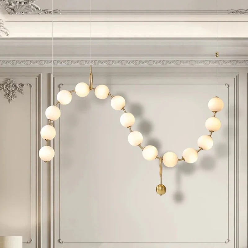 

2025 Living room ceiling pendant light in gold colour with magic beans, glass shade, adjustable hanging wire, suitable for bar