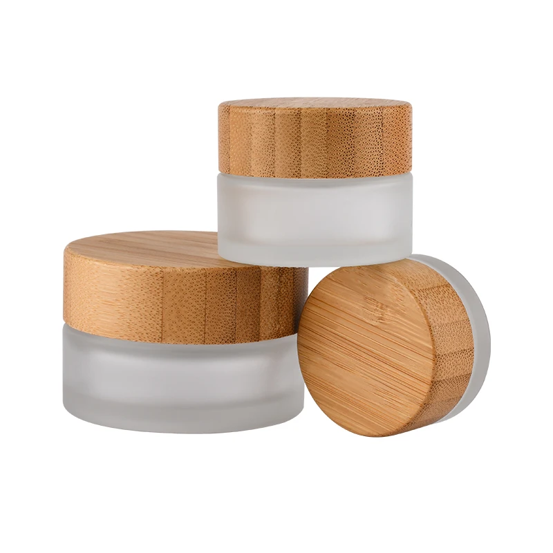 

Hot sale cosmetic face cream container 5ml 15ml 30ml 50ml 100ml frosted clear glass jar with bamboo wood lid 200g