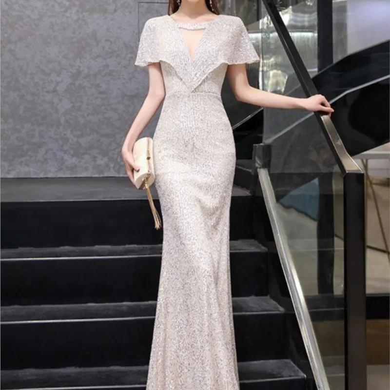 

A silver banquet dress with fish-tail host's sequined charm