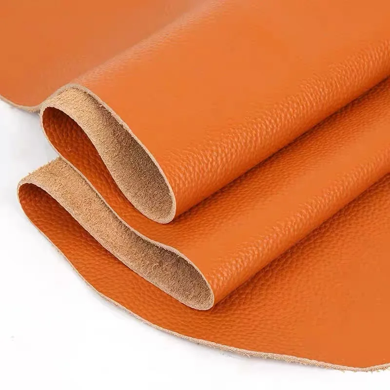 Capa superior naranja, material de piel de vaca, patrón de lichi, asiento de sofá, cabecero, paquete suave, tela de cuero, piel de vaca real naranja miel