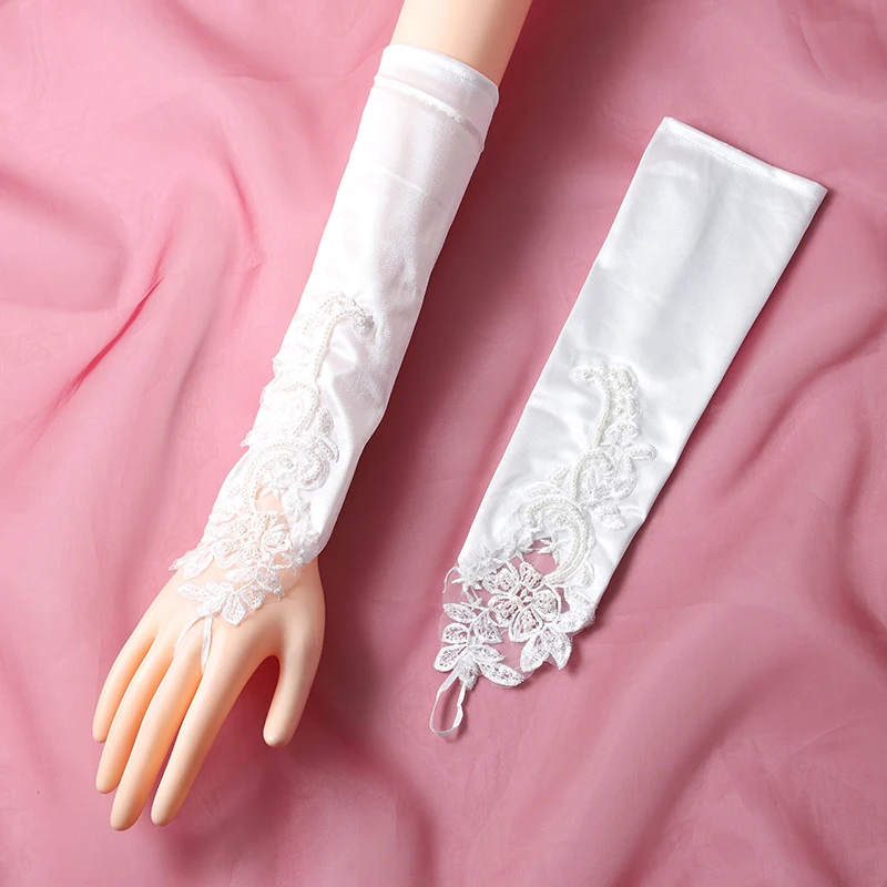 The bride's accessory is a pair of white ring style long gloves suitable for women's wedding parties