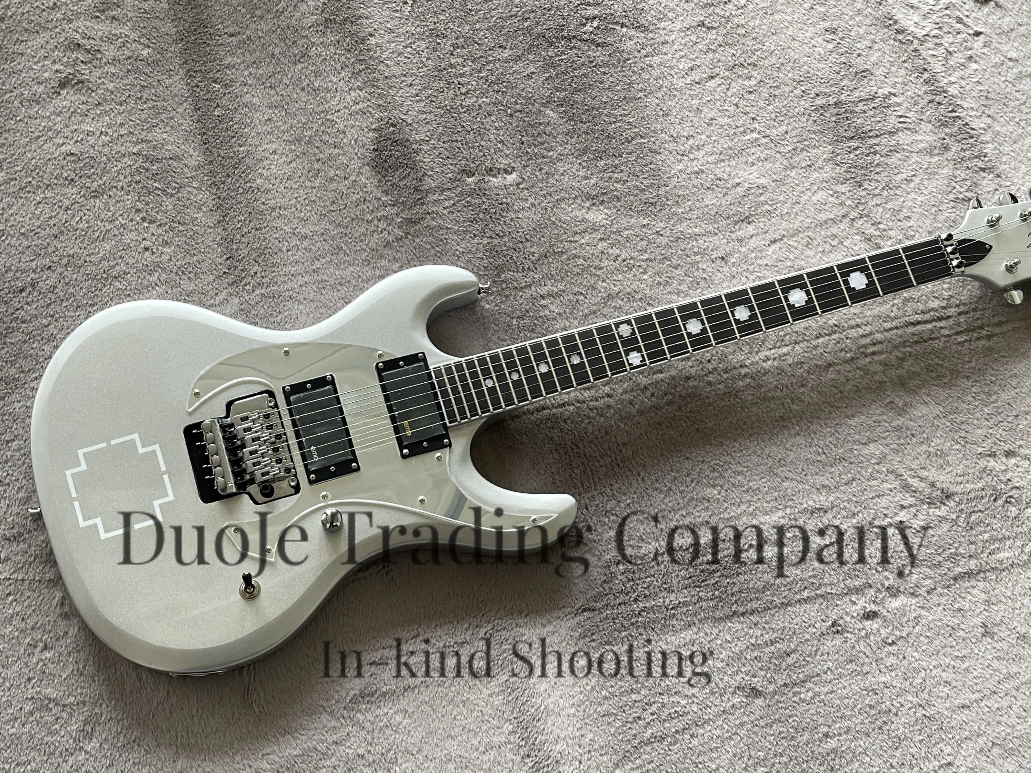 Silver guitar with Tremolo bridge, Maple neck set in body, Rosewood fingerboard with cross pearl inlays, Mirror pickguard