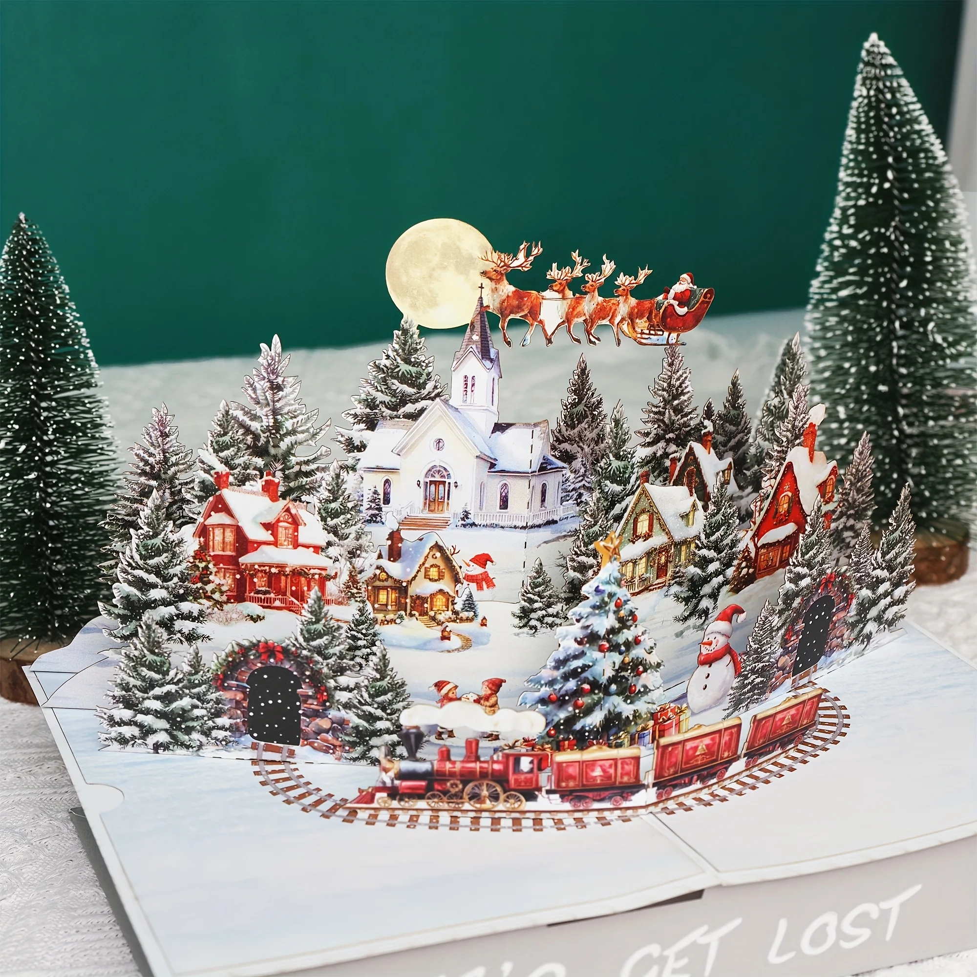 بطاقة عيد الميلاد المنبثقة ثلاثية الأبعاد مع بطاقة تهنئة لعطلة القرية الثلجية سانتا وأصدقاء (تصميم مونليت)