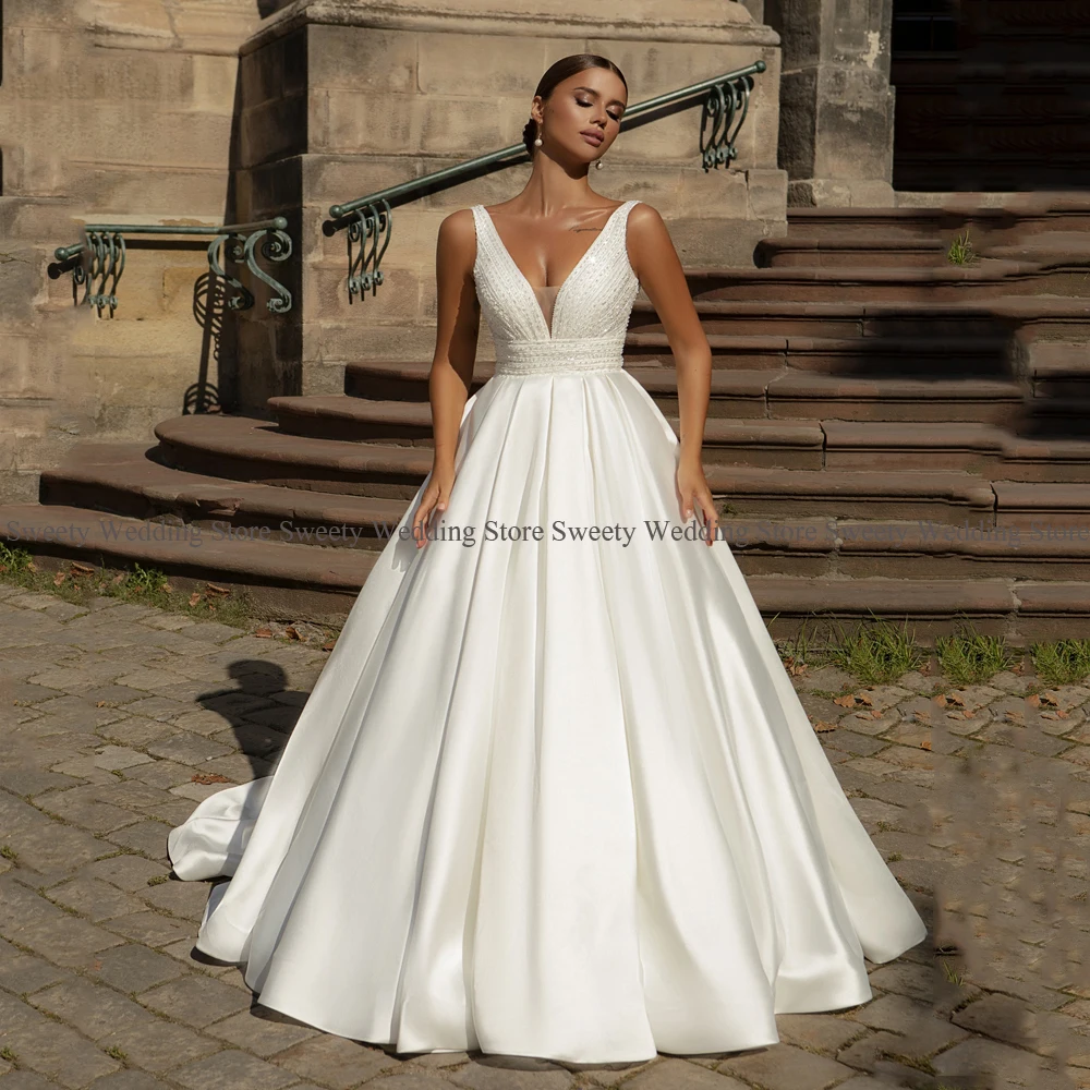 

2023 Luxury Beading Satin Wedding Dresses Sexy V Neck Sleeveless Sequin Sweep Train Ball Gown Corset Bridal Robe Mariage