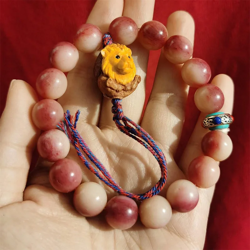 Camel bone bloodstone bracelet with 12mm round beads, paired with a coin-shaped Buddha head and a small lion, featuring a unique