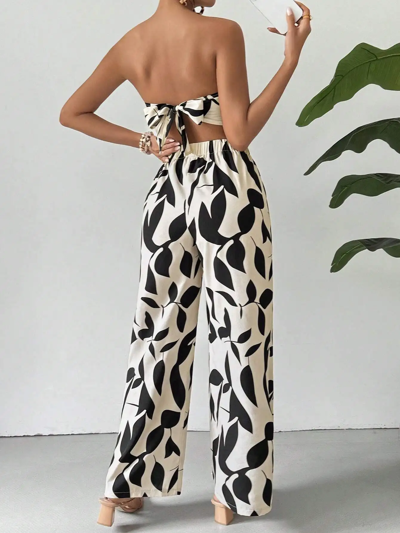 Black Leaf Print Wide Leg Set Vertical View - Strapless Crop Top and Flowing Pants Matching Outfit
